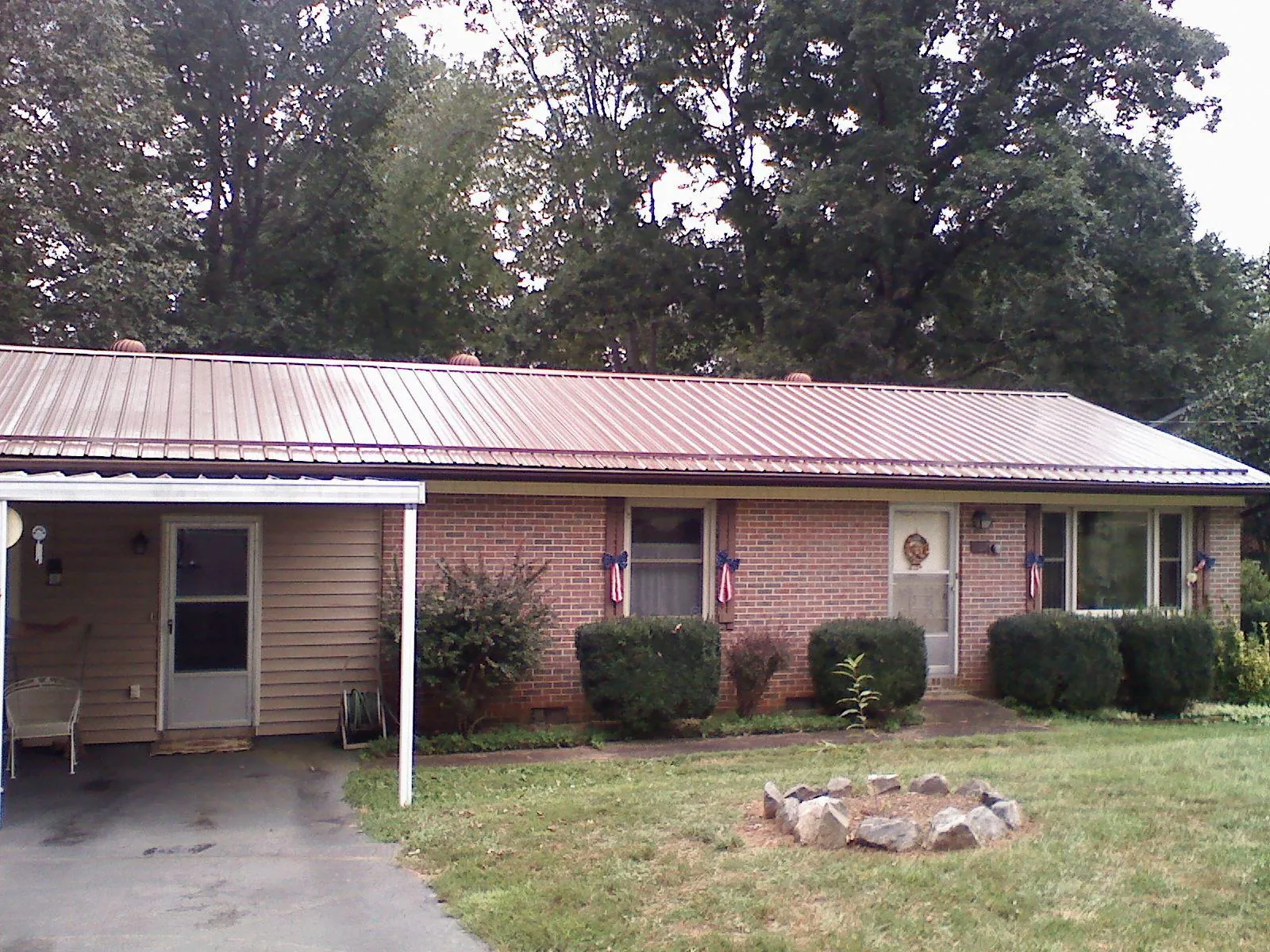 Bronze metal roof and carport on a brick ranch home — Roof Repair work by our crew in West Long Branch