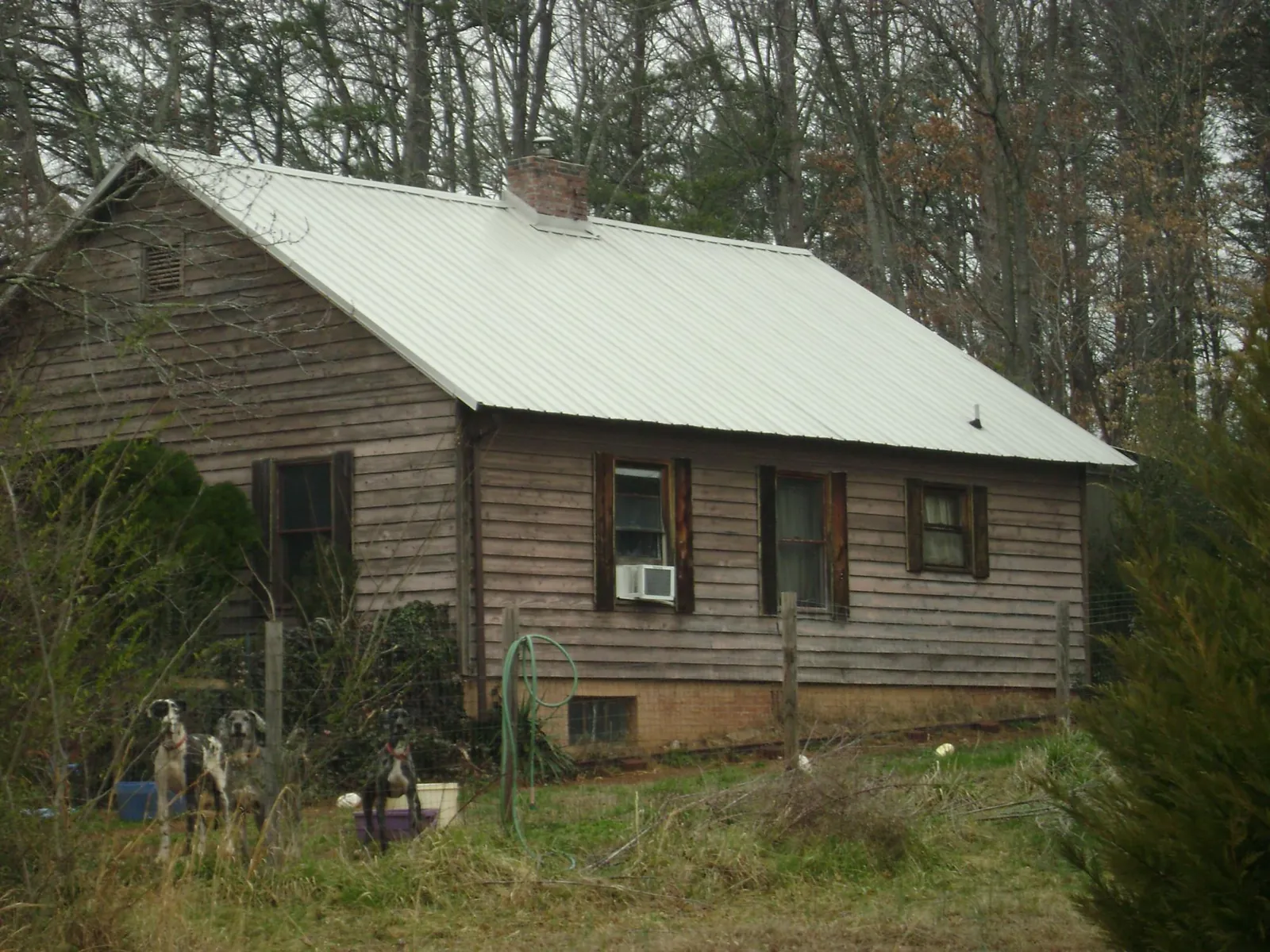 White metal roof on an old wood sided farmhouse, from a Metal Roof Installation job in West Long Branch